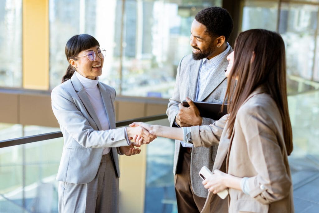 Business professionals engage in productive conversation at modern office setting in daylight