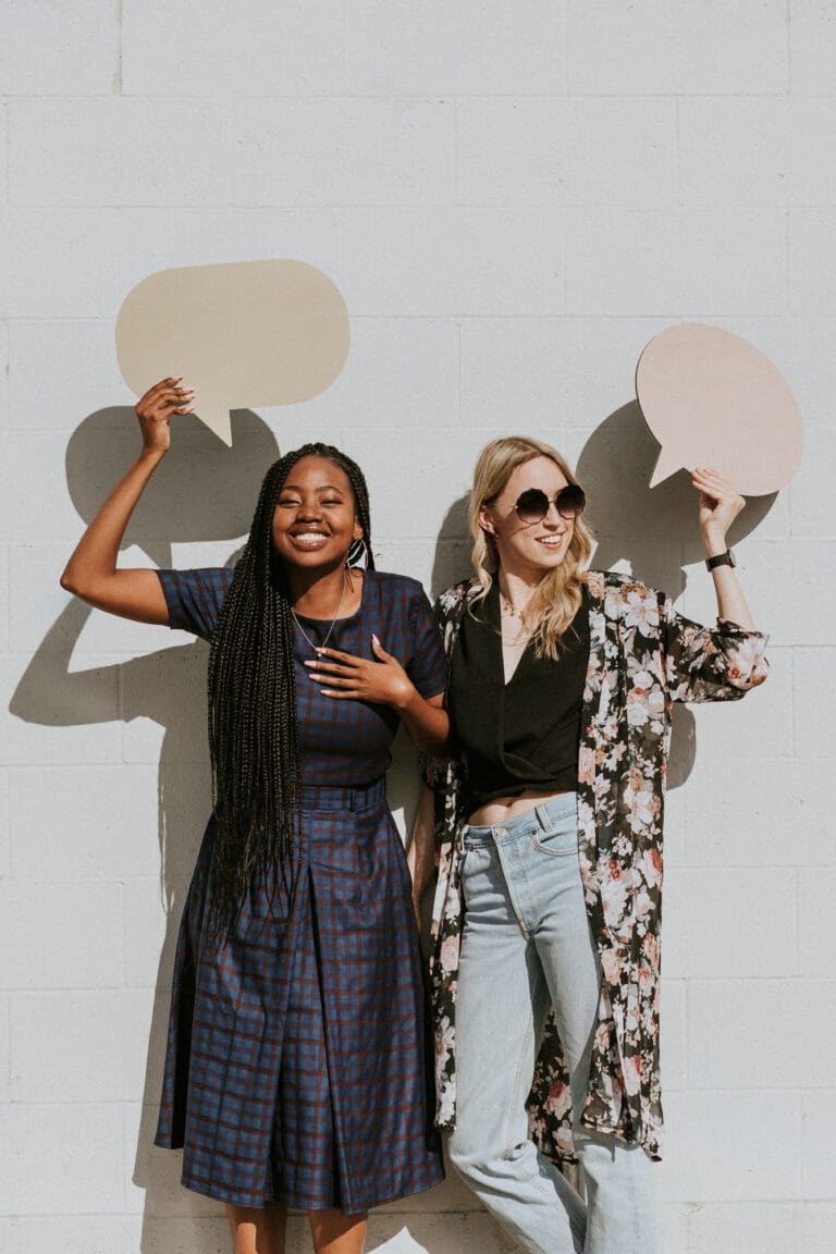 Women holding speech bubbles