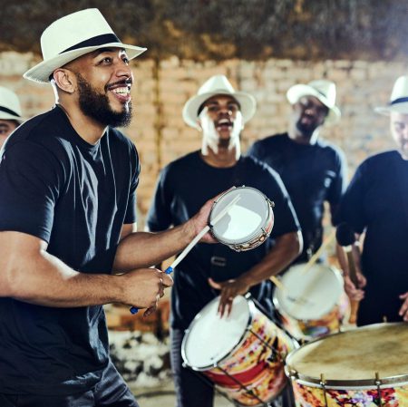 Feeling the rhythm in the drums. Shot of a group of musical performers playing together indoors.