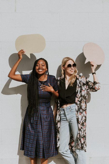 Women holding speech bubbles